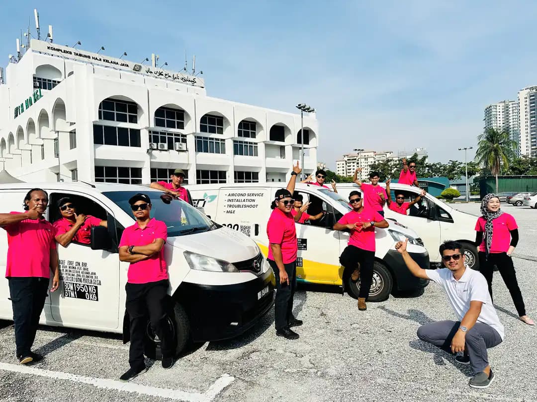 Selangor-based GenPlus Air-Conditioning team beside their dedicated service vehicles